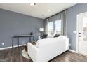 Cozy living room featuring a white couch, stylish gray accent wall and modern decor at 337 Skylar Se Way, Atlanta, GA 30315