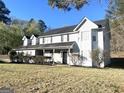 Traditional two-story home with covered porch, dormer windows and mature landscaping at 1273 Baywood Gln, Lithonia, GA 30058