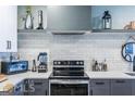 Modern kitchen with stainless steel appliances, white subway tile backsplash and ample counter space at 16 Becker Nw Pl, Atlanta, GA 30307