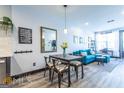 Open-concept living space with dining area featuring stylish decor and a comfortable blue sofa at 16 Becker Nw Pl, Atlanta, GA 30307