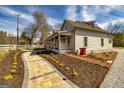 Well-maintained home with a covered porch and brick pathway, set in a manicured lawn with a charming white fence at 721 Wedowee St, Bowdon, GA 30108