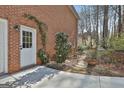 Private backyard with a stone pathway leading through lush landscaping at 300 The Enclave, Peachtree City, GA 30269