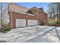 Spacious three-car garage and extended driveway enhance this property's functionality at 300 The Enclave, Peachtree City, GA 30269