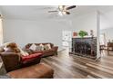 Open-concept living room with a fireplace, hardwood floors, and comfortable seating area at 152 Summerfield Dr, Mcdonough, GA 30253