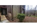 Weathered exterior highlighting a mature shrub and weathered wood at 5796 Par Four Ct, Lithonia, GA 30038