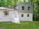 Charming two-story home featuring a bay window, painted brick, and a welcoming light blue front door at 6192 Holiday Blvd, Forest Park, GA 30297
