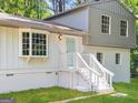 Charming two-story home featuring a bay window, painted brick, and a welcoming light blue front door at 6192 Holiday Blvd, Forest Park, GA 30297