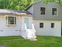 Charming two-story home featuring a bay window, painted brick, and a welcoming light blue front door at 6192 Holiday Blvd, Forest Park, GA 30297