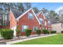 Side view of a two story brick home with an attached garage and well-maintained landscaping at 139 Surge Stone Ln, Stockbridge, GA 30281