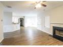 Spacious living room with wood floors, a fireplace, and a seamless transition to the dining area at 139 Surge Stone Ln, Stockbridge, GA 30281