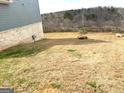 Large backyard with a wooden fence and natural rock features at 413 Samara Ct, Fairburn, GA 30213
