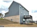 Rear view of a two-story home with a wooden deck at 413 Samara Ct, Fairburn, GA 30213