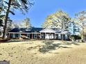 Beautiful one-story brick home with a spacious front yard and classic design, set against a backdrop of mature trees at 170 White Rd, Fayetteville, GA 30214