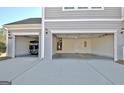 Spacious three-car garage with ample parking and storage space at 305 Roundwood Way, Peachtree City, GA 30269
