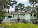 Back of the home featuring light green siding, a small patio, fenced yard and basement door at 2222 Beecher, Atlanta, GA 30311