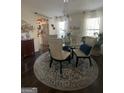 Elegant dining room with a glass table, chandelier, and coordinated decor at 133 Ventura Trl, Stockbridge, GA 30281