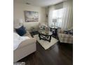 Cozy living room with stylish furnishings, a plush rug, and ample natural light at 133 Ventura Trl, Stockbridge, GA 30281