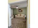 Cozy living room featuring soft carpet, neutral paint, and a comfortable seating arrangement at 7354 Spoleto Loop, Fairburn, GA 30213