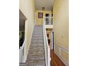 Carpeted staircase with white railing, leading to the upper level of the home at 7354 Spoleto Loop, Fairburn, GA 30213