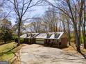 An eye-level exterior view shows the home's facade, garage, and mature trees on a large lot at 327 Old Muse Rd, Carrollton, GA 30116