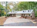 View of the home's facade, garage, and landscaping at 327 Old Muse Rd, Carrollton, GA 30116