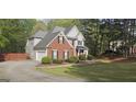 Home exterior showing brick and siding, garage, and landscaped yard in a suburban setting at 255 Squire Ln, Fayetteville, GA 30214