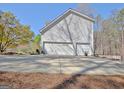 Spacious three-car garage and large driveway offering ample parking at 55 Sturgess Run, Sharpsburg, GA 30277