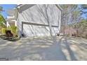Spacious three-car garage and large driveway offering ample parking at 55 Sturgess Run, Sharpsburg, GA 30277
