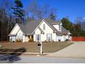 Well-maintained home features a lush lawn, attached garage, and complementary gray shutters at 180 Sunderland Cir, Fayetteville, GA 30215