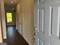 View of the home's entryway with wood floors leading to a naturally lit living area at 4130 Chapel Hill Reserve, Douglasville, GA 30135