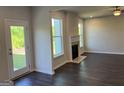 Open concept living room with fireplace and large windows with views to the backyard at 4130 Chapel Hill Reserve, Douglasville, GA 30135