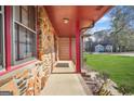 Covered porch with stone accent walls, offering a charming entrance to the home at 2759 Turner Valley Sw Cir, Conyers, GA 30094