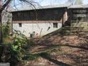 The back of the brick home shows a partially finished basement on a sloped lot at 2102 Mulkey Sw Rd, Marietta, GA 30008