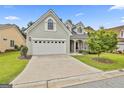 Well maintained home featuring a three-car garage, stone accents, and a driveway at 211 Collierstown Way, Peachtree City, GA 30269