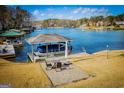 Waterfront property featuring a covered dock with boat, seating area, and beautiful lake views at 2304 Larchmont Ct, Villa Rica, GA 30180