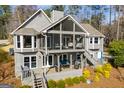 Back exterior view showcasing multilevel decks, screened porch with seating, and well-maintained landscaping at 2304 Larchmont Ct, Villa Rica, GA 30180