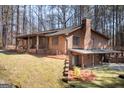View of the exterior with brickwork, back patio and mature trees on a well-maintained lawn at 222 Providence Rd, Fayetteville, GA 30215