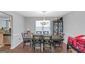 Spacious dining room features a modern chandelier and a large table with seating for eight at 1191 Berryhill Dr, Lithonia, GA 30058