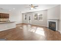 Open living area with hardwood floors, a fireplace, and lots of natural light at 1064 Lear Dr, Locust Grove, GA 30248