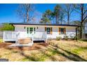 Charming home featuring a light green front door and a cozy wooden deck at 116 Carroll St, Temple, GA 30179