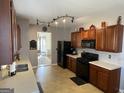 Spacious kitchen featuring wood cabinets, modern appliances, and a view of the adjoining living room at 2626 Summit Sw Pkwy, Atlanta, GA 30331