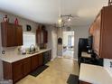 Well-lit kitchen with wood cabinets, black appliances, and tiled backsplash at 2626 Summit Sw Pkwy, Atlanta, GA 30331