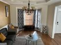 Bright living room featuring hardwood floors, large windows, and stylish curtains at 2626 Summit Sw Pkwy, Atlanta, GA 30331