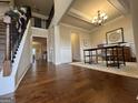Inviting foyer with hardwood floors, staircase, and views into other rooms of the home at 101 Elkins Blvd # 53, Locust Grove, GA 30248