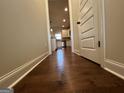 Hallway with hardwood floors and views to the kitchen at 101 Elkins Blvd # 53, Locust Grove, GA 30248