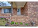 Inviting brick front porch with decorative metal railing and a white front door, enhanced by a well-maintained brick facade at 9138 Parnell Sw St, Covington, GA 30014