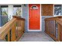 Inviting orange front door and well-maintained wooden porch with modern architectural details at 1894 Evans Evans Sw Dr, Atlanta, GA 30310