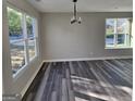 Cozy living area with luxury vinyl plank flooring and large windows for natural light at 3724 River Ridge Ct, Decatur, GA 30034