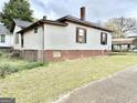 Charming home with traditional architectural details and a cozy backyard at 45 Poplar St, Porterdale, GA 30014