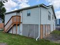 Two-story house with light siding, stairs to the main entrance, and lattice hiding a crawl space at 5549 Highway 42, Ellenwood, GA 30294
